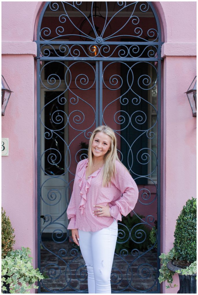 Rainbow Row Senior Portrait with pink home in Charleston SC