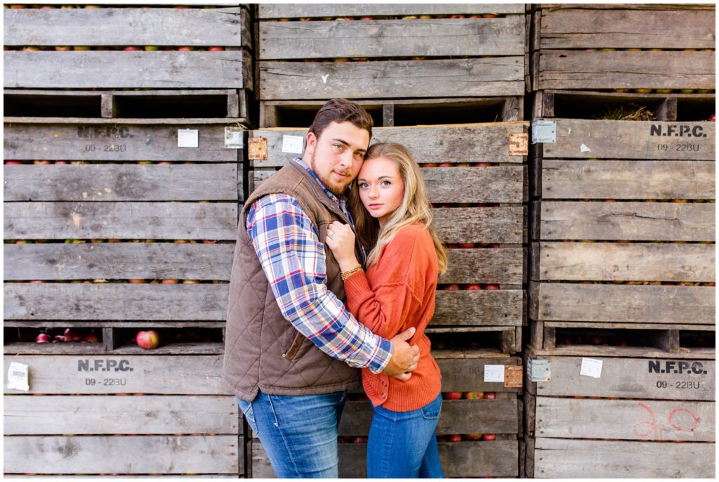 Apple orchard engagement photo with wooden crates