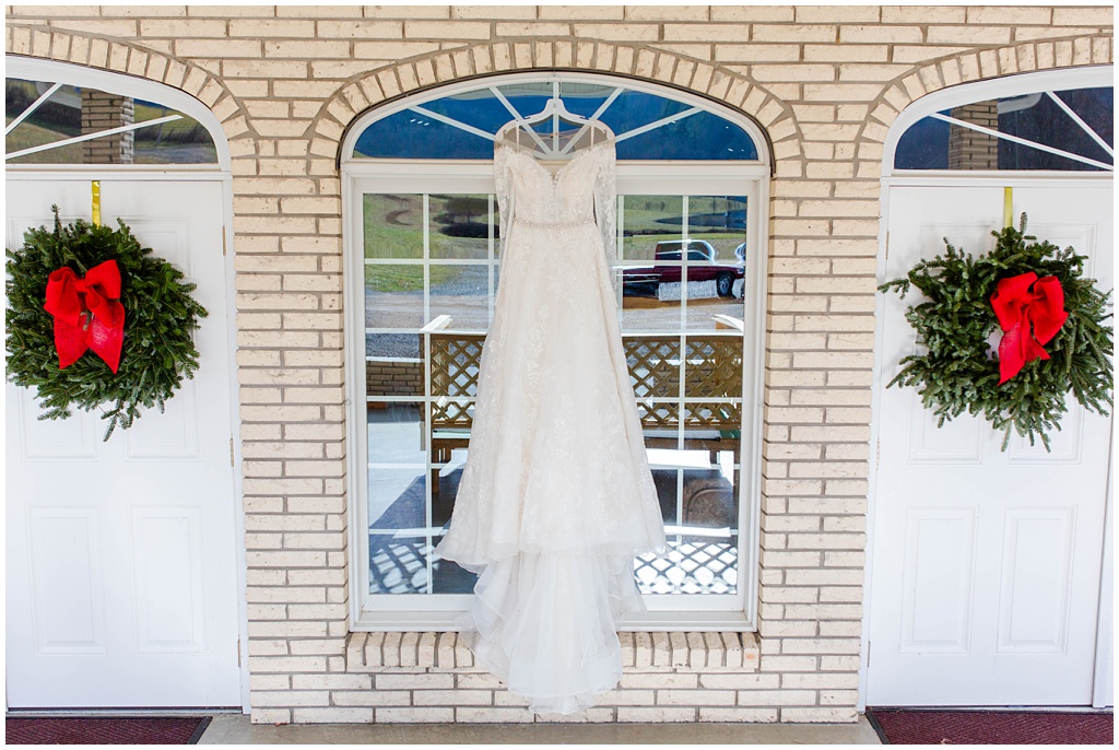 The bride's wedding dress outside Victory Baptist Church with Christmas wreaths