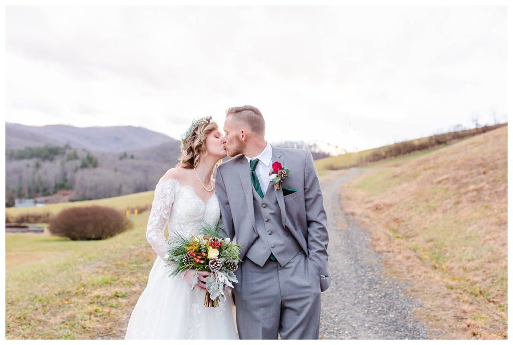 Bride and groom kissing outside with mountain views