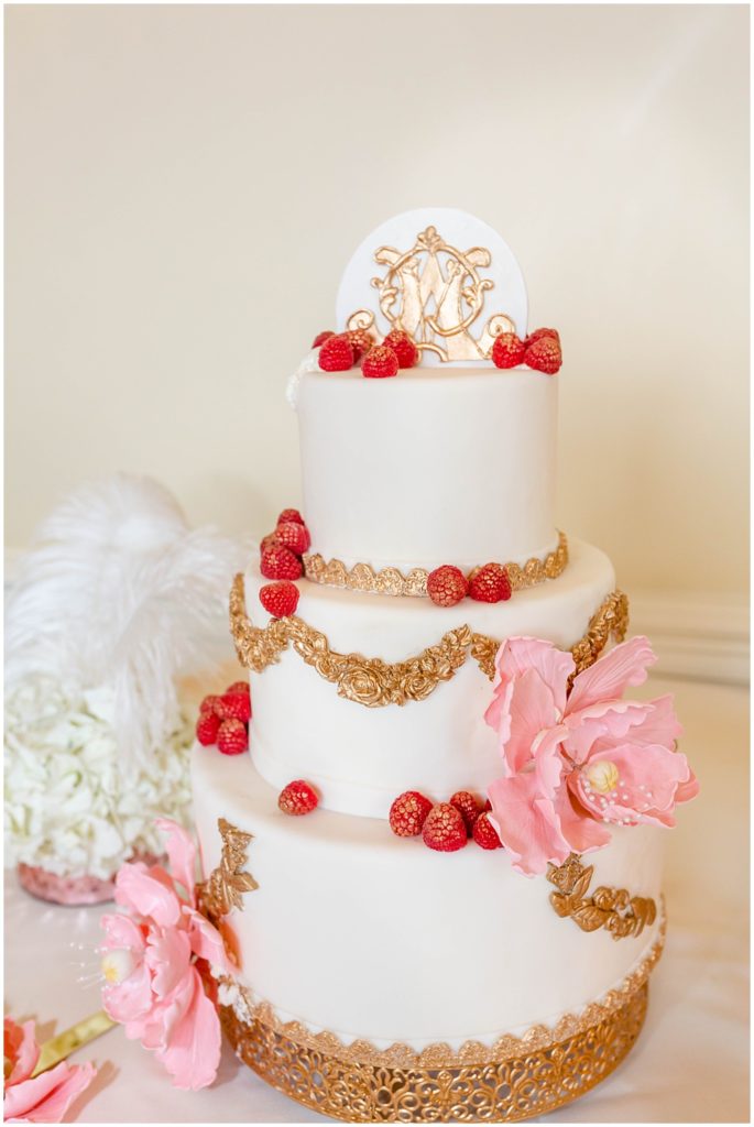 3 Tiered wedding cake with gold antique accents and red berries