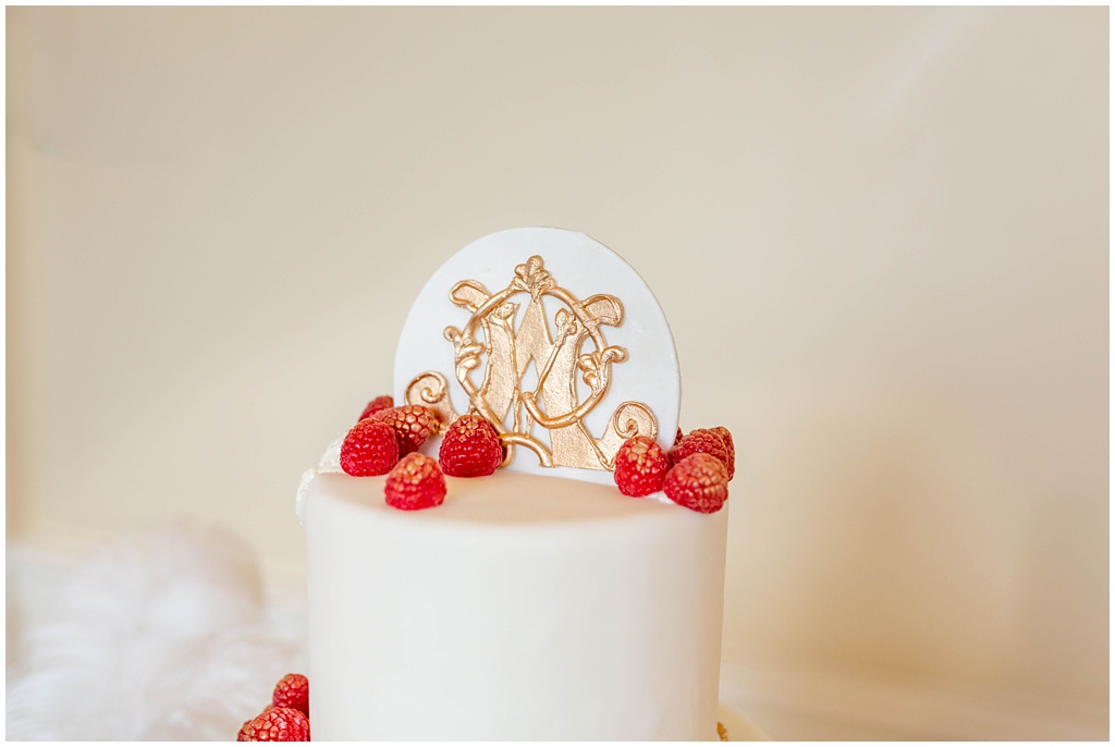 3 Tiered wedding cake with gold antique accents and red berries made by the Inn at Biltmore Estate