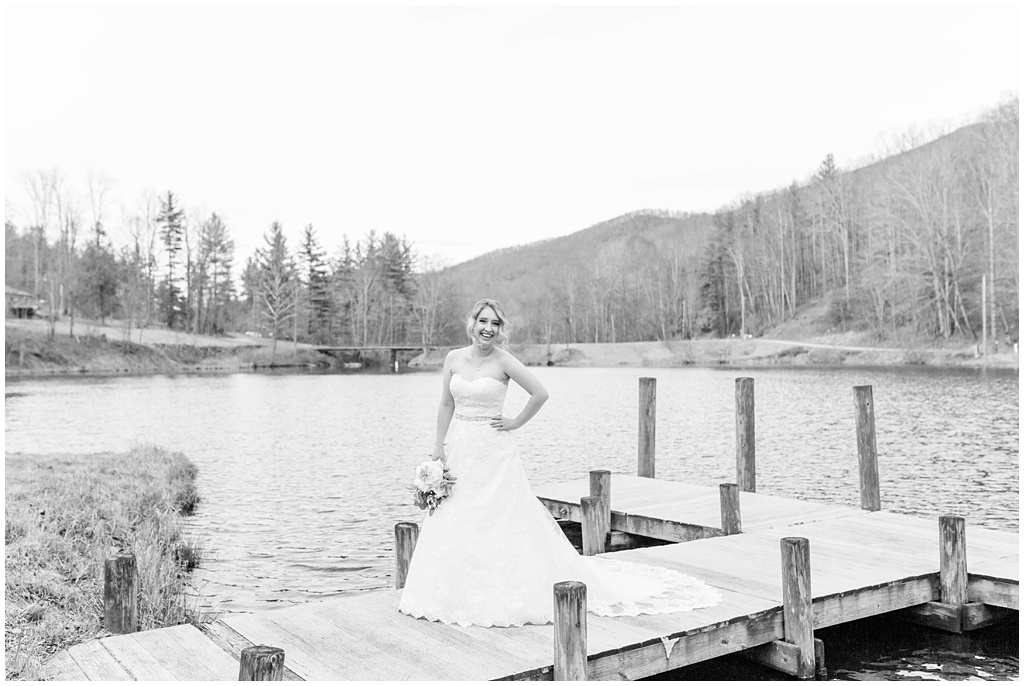 black and white bridal portrait on the dock at the lake