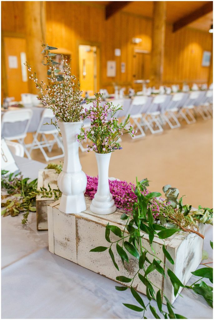 Purple florals on the table at their wedding reception