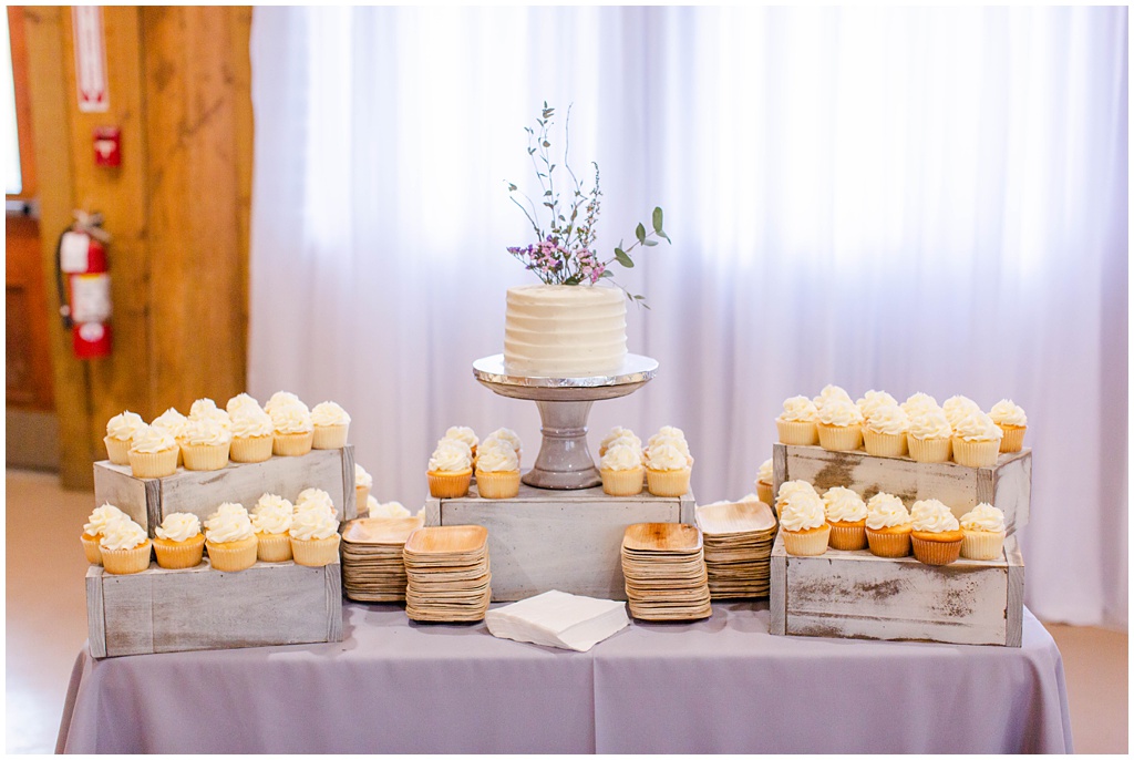 Cupcake and small wedding cake display on lavender dessert table