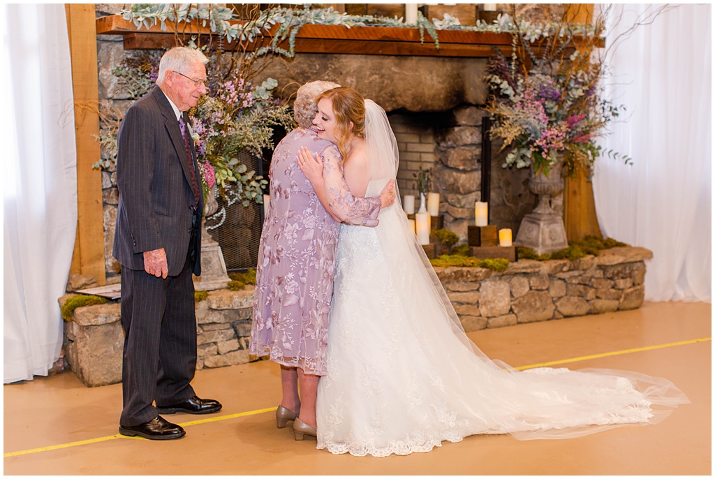 The bride hugs her grandmother after seeing her for the first time at the wedding
