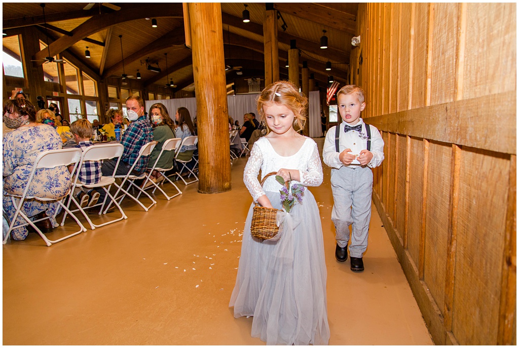 The flower girl and ring bearer making their way down the ceremony aisle.