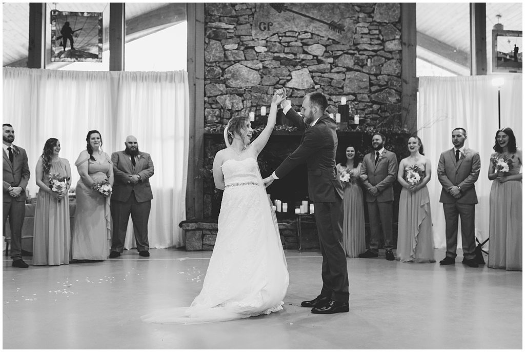 Black and white photo of the bride and groom sharing their first dance.