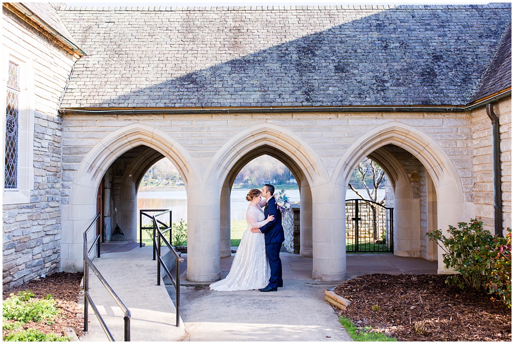 Bride and groom romantic photo under an archway.