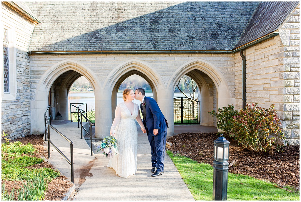 Bride and groom portrait at an outdoor archway.