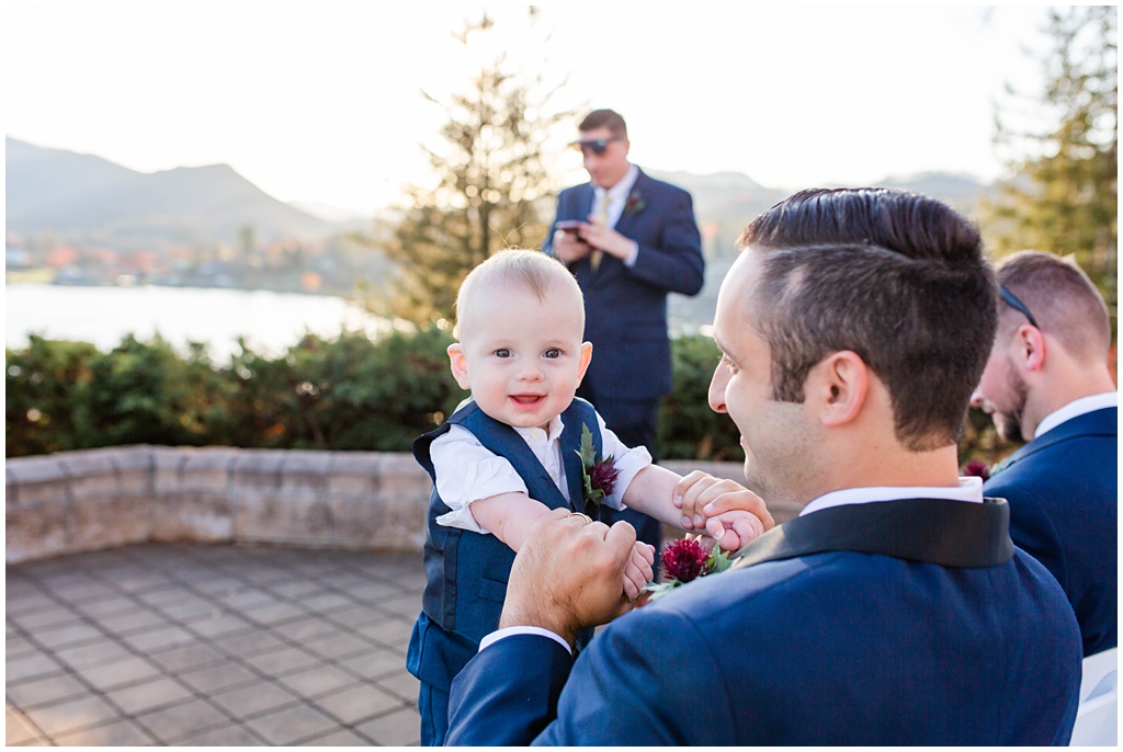 The groom holding onto the ring bearer after the wedding ceremony.