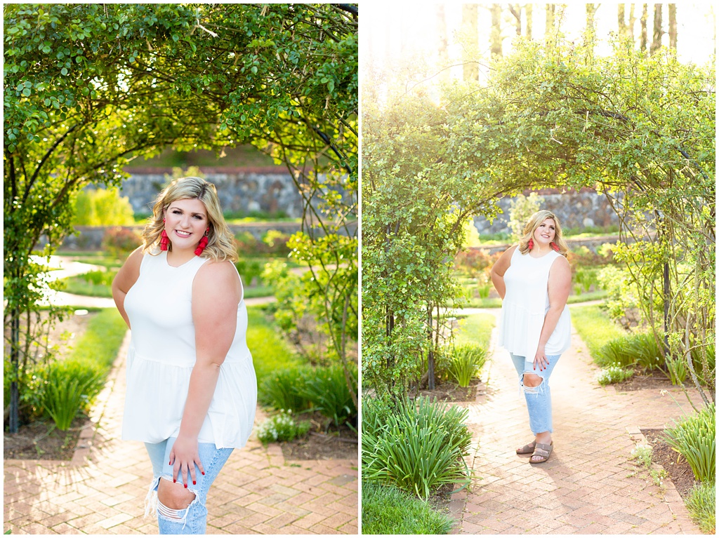 Madison poses under an arch of greenery in the garden.