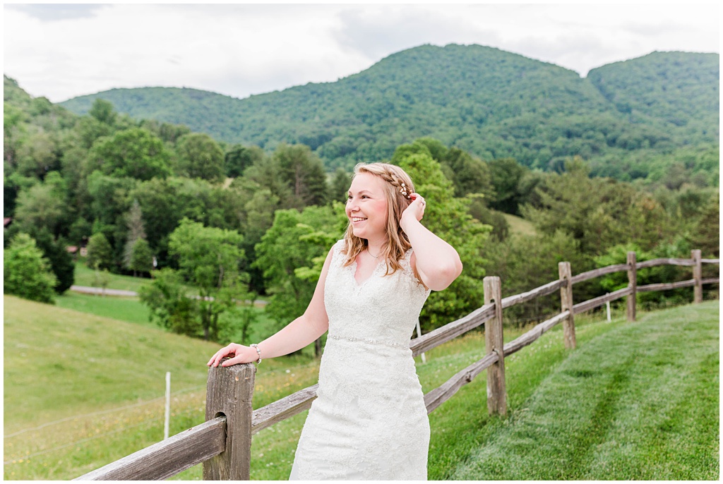 Spring bridal portraits in the mountains of NC along a fence line at Chestnut Ridge.