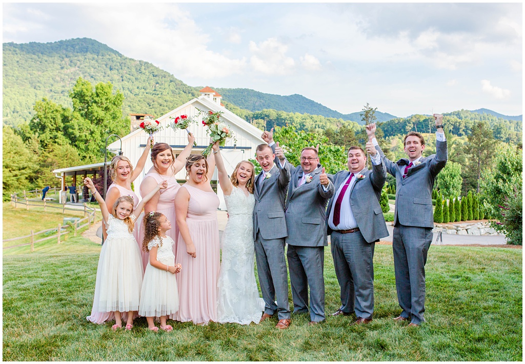 The bridal party together on top of a hill at Chestnut Ridge with Mountains in the background.