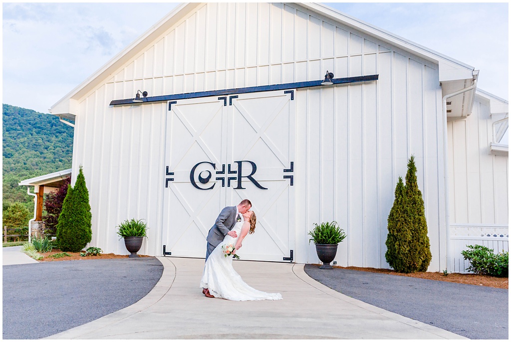 Bride and groom portrait in front of the barn doors at Chestnut Ridge.