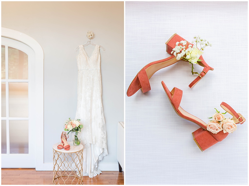 The bride's dress hanging on a hanging and her coral shoes next to it.