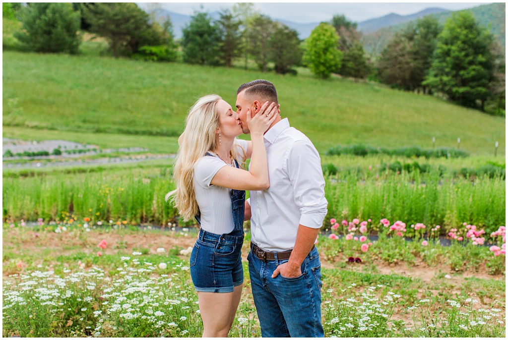 Mary and Matthew share a kiss in a field of wild flowers.