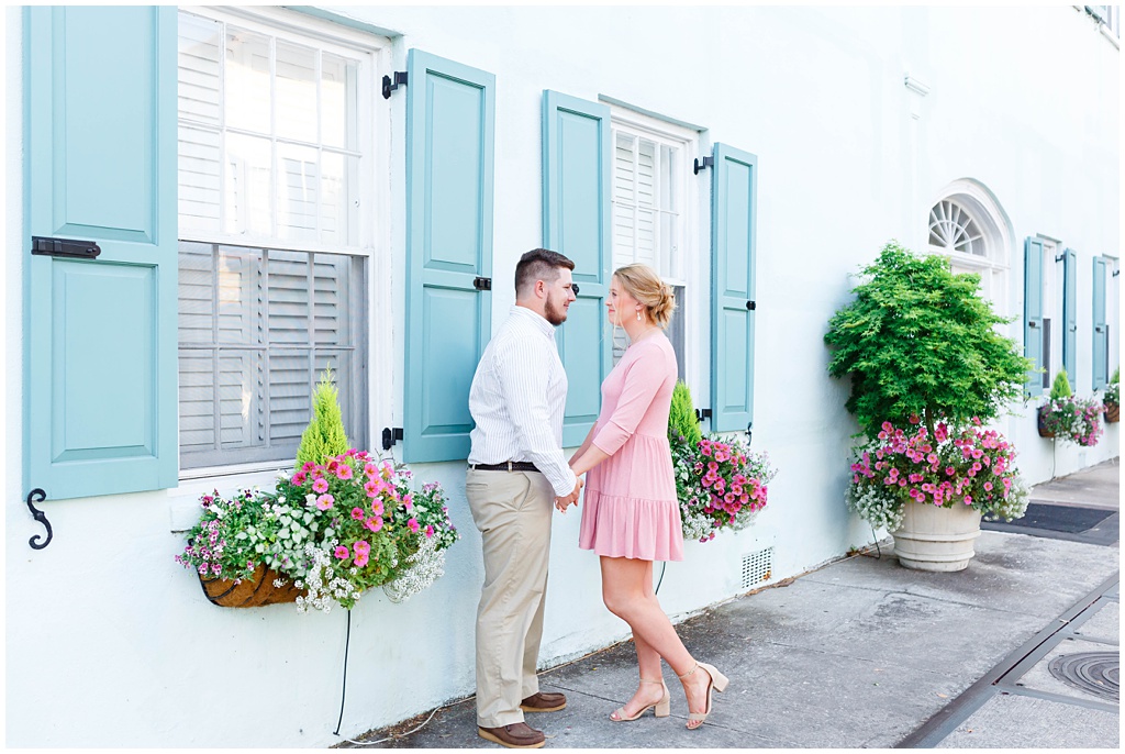 Downtown Charleston Engagement photos on Rainbow Row with a teal house.