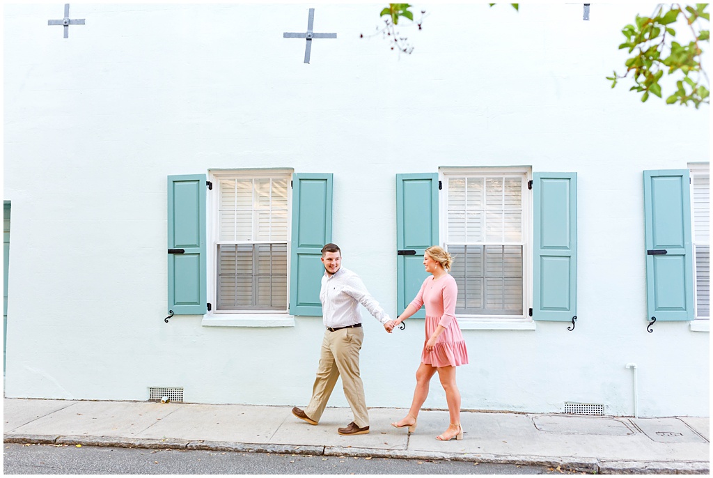 Downtown Charleston Engagement photos on Rainbow Row with a teal house.