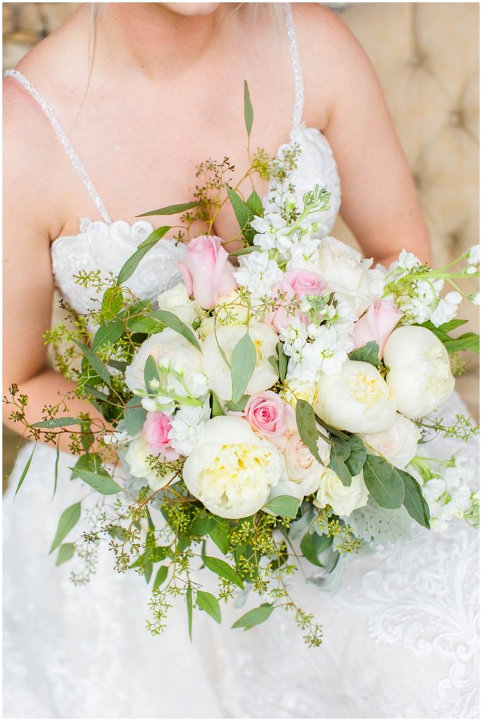 A pink and white bridal bouquet with roses and peonies.