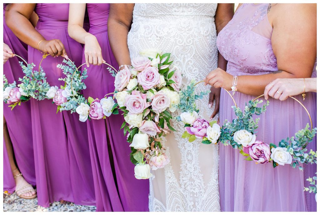 The bridesmaids had a metal hoop wreath instead of a traditional bouquet.