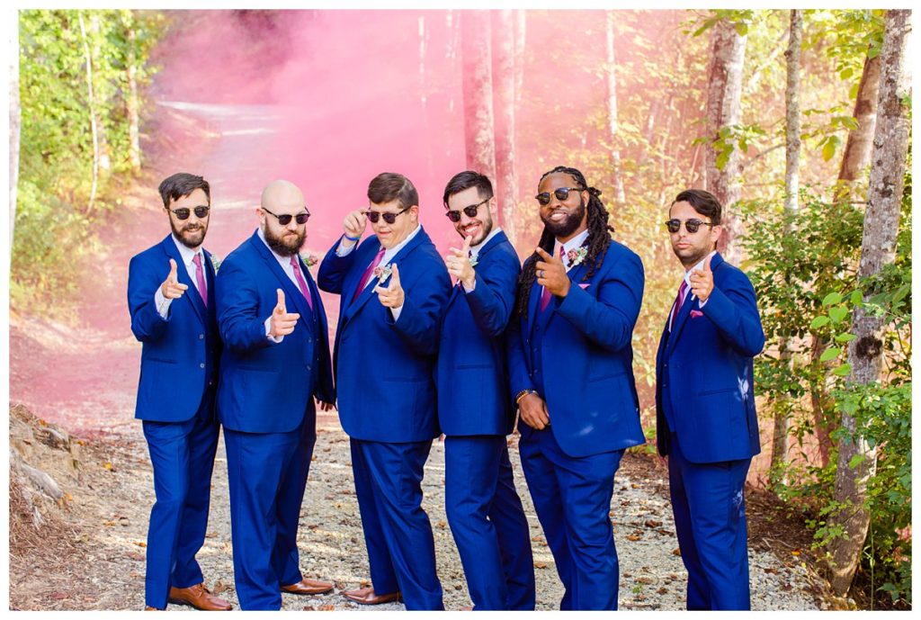 Groomsmen portrait with a pink smoke bomb in the mountains of NC.