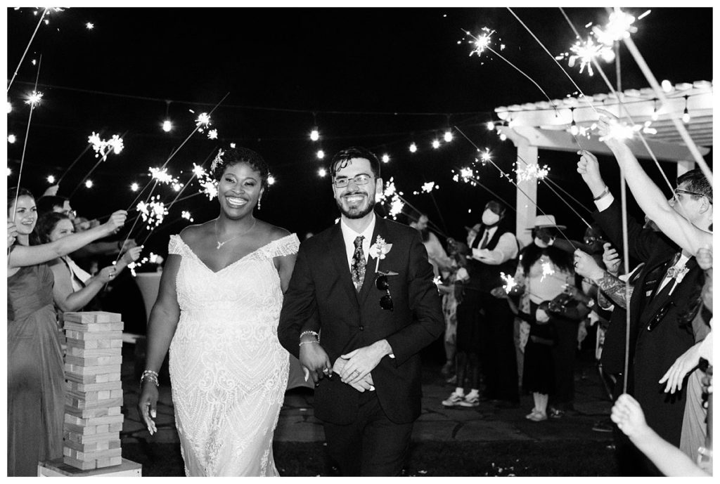 Black and white image of the couple during their sparkler exit from their reception.