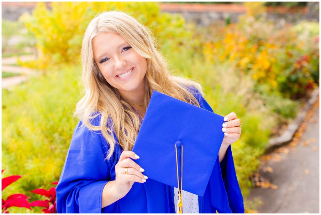 High school senior portraits with a blue cap and gown