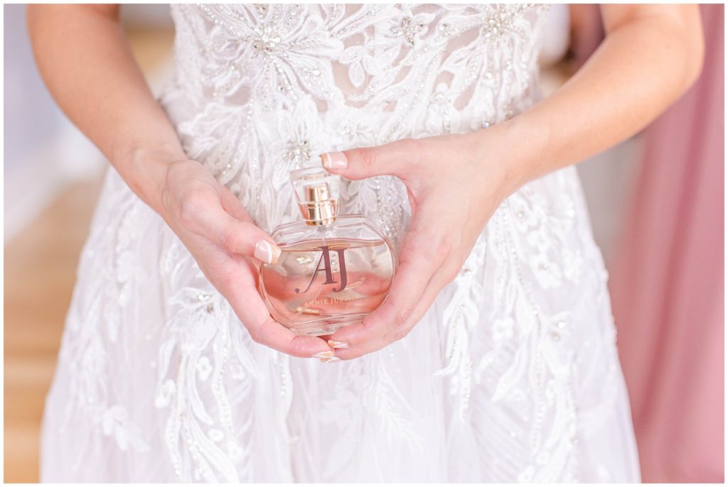The bride holding romantic perfume for her wedding day.