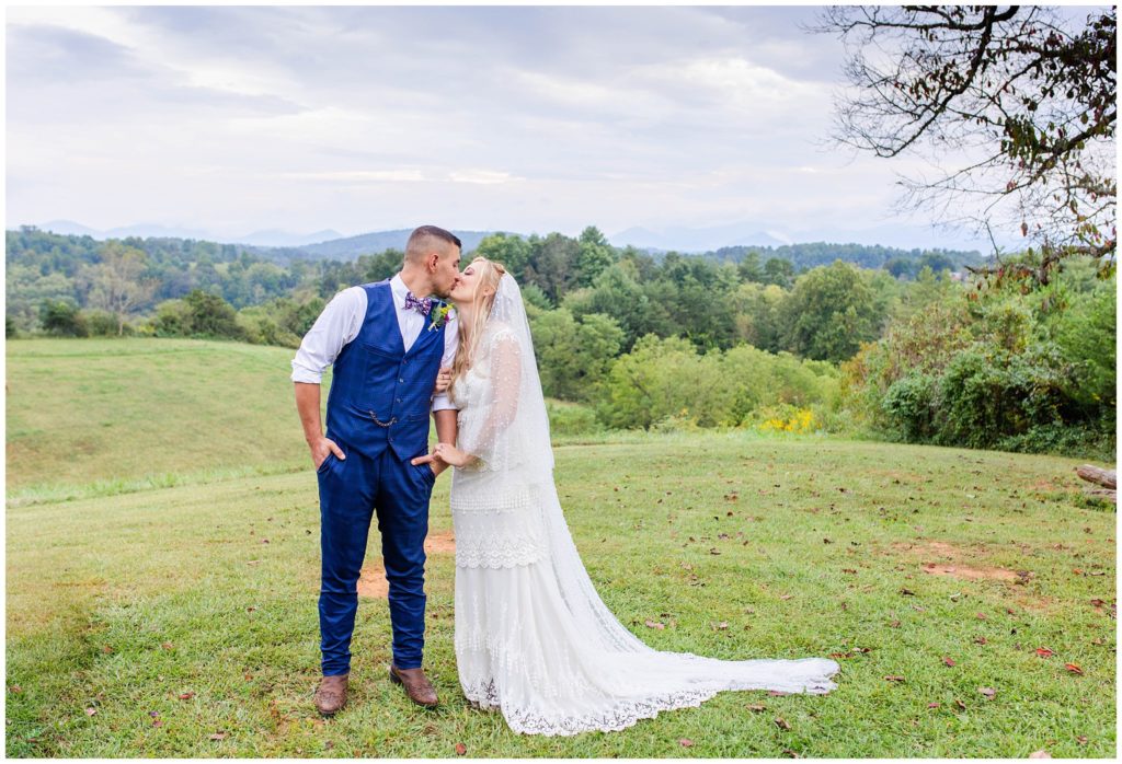 The bride and groom share a kiss at Lewis Farm | Asheville Wedding Photographer
