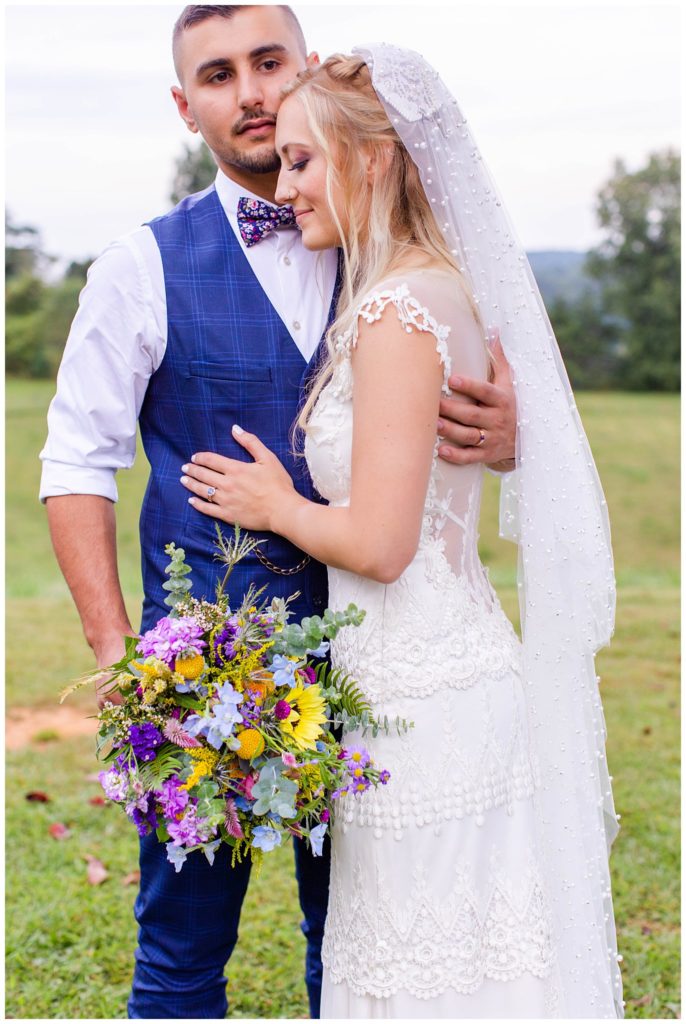 The bride hugs her groom at Lewis Farm | Asheville Wedding Photographer