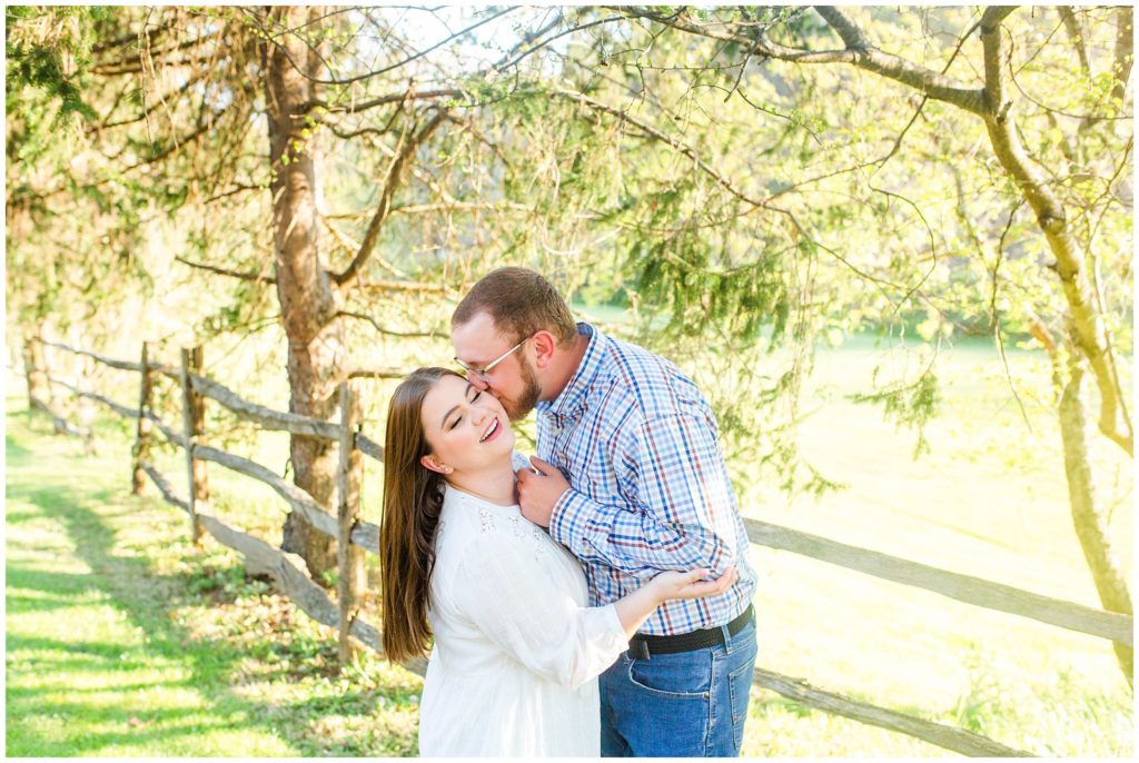 Lane leans in to kiss Hannah on the cheek during their engagement session | Asheville Engagement Photographer