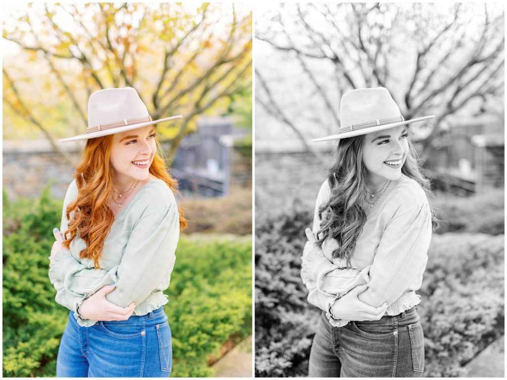 High school senior photos of a girl wearing jeans and a green shirt with a tan hat at the NC arboretum in Asheville.