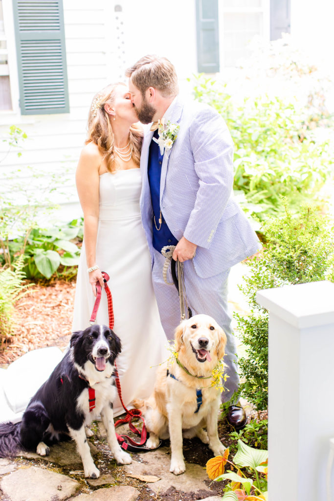 couple poses with their two dogs for their wedding
