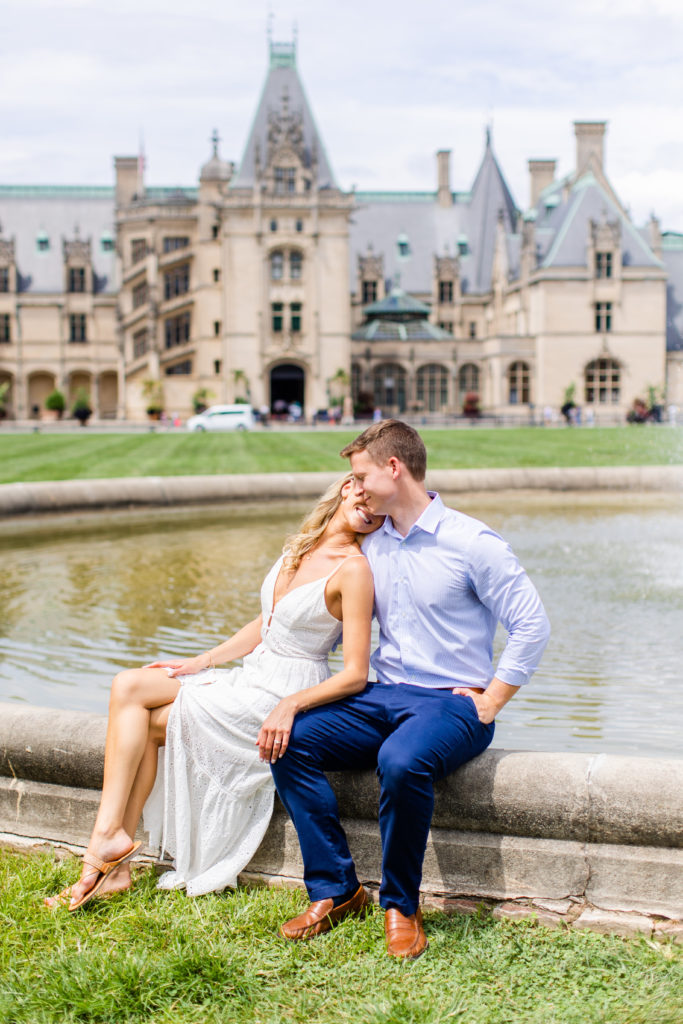 Couple who just got engaged poses in front of the Biltmore Estate fountain