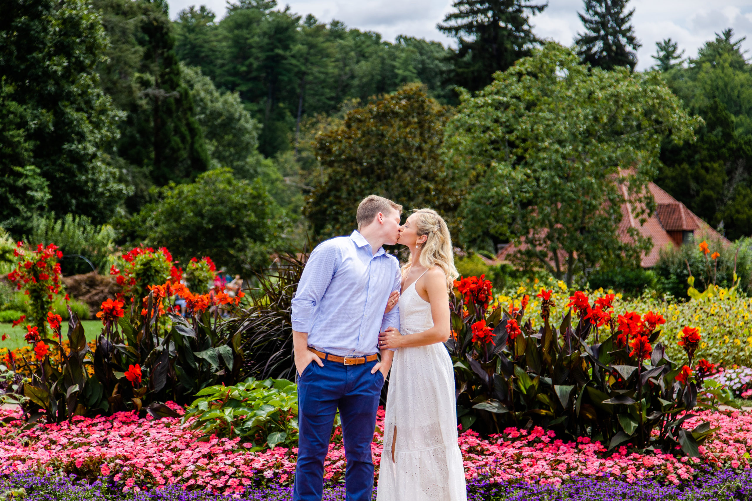 Recently engaged couple kisses in Biltmore Estate gardens