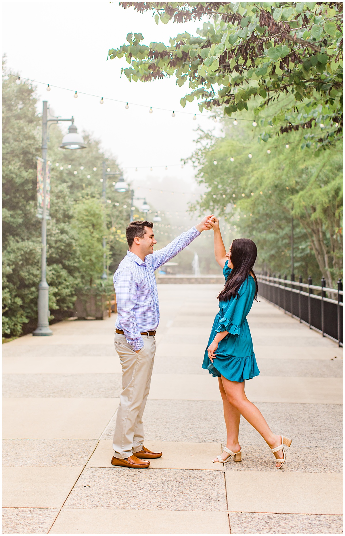 couple twirling in walkway for their engagement session