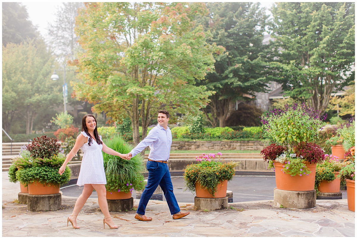 couple poses in NC Arboretum for their engagement session