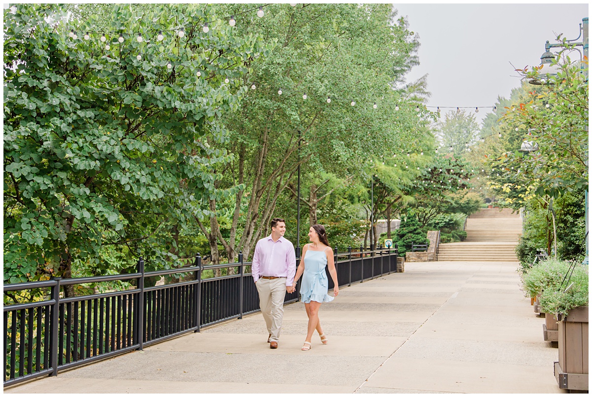 couple walking and holding hands for their Asheville engagement session