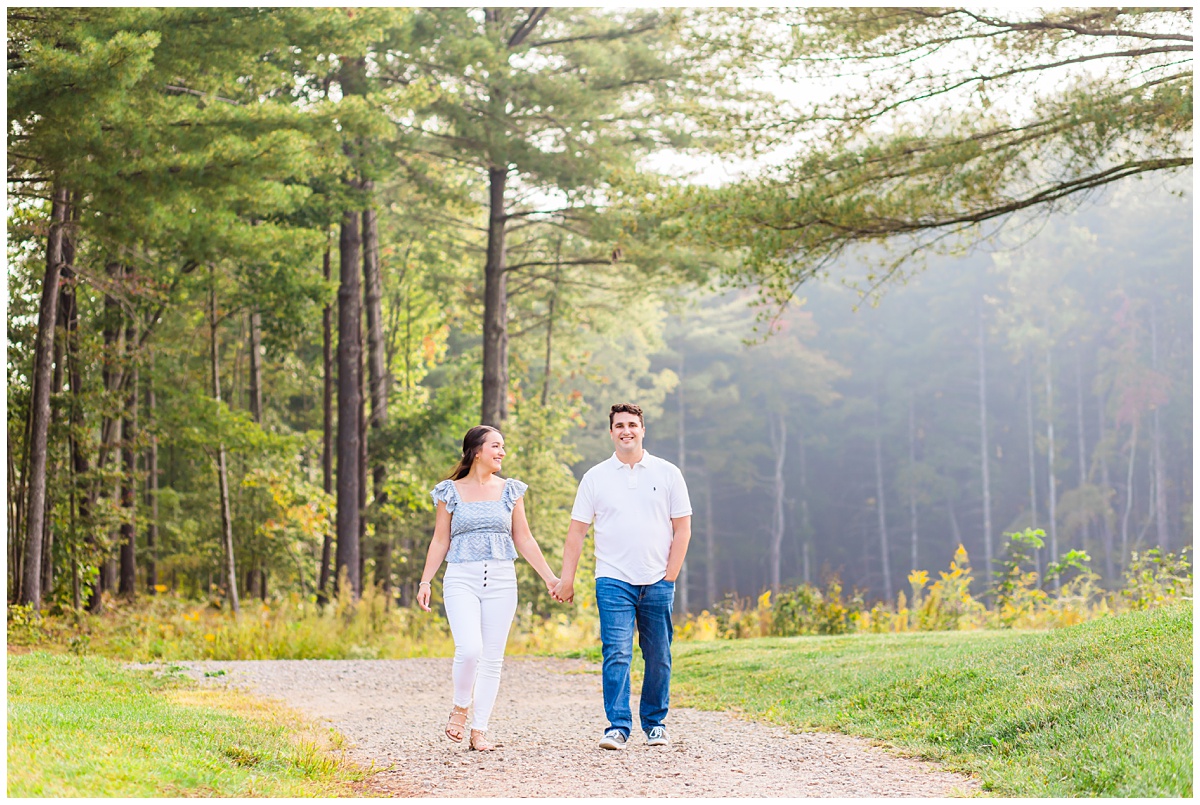 couple walking together for their Asheville engagement session at the NC Arboretum