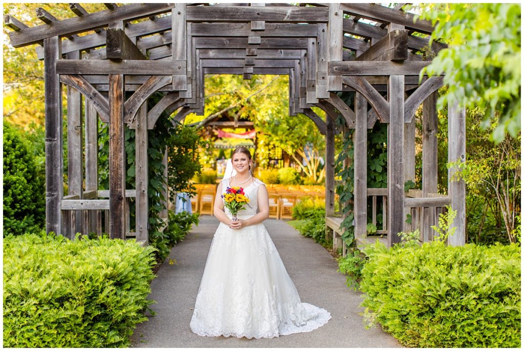bride poses at the NC Arboretum for her bridal portraits