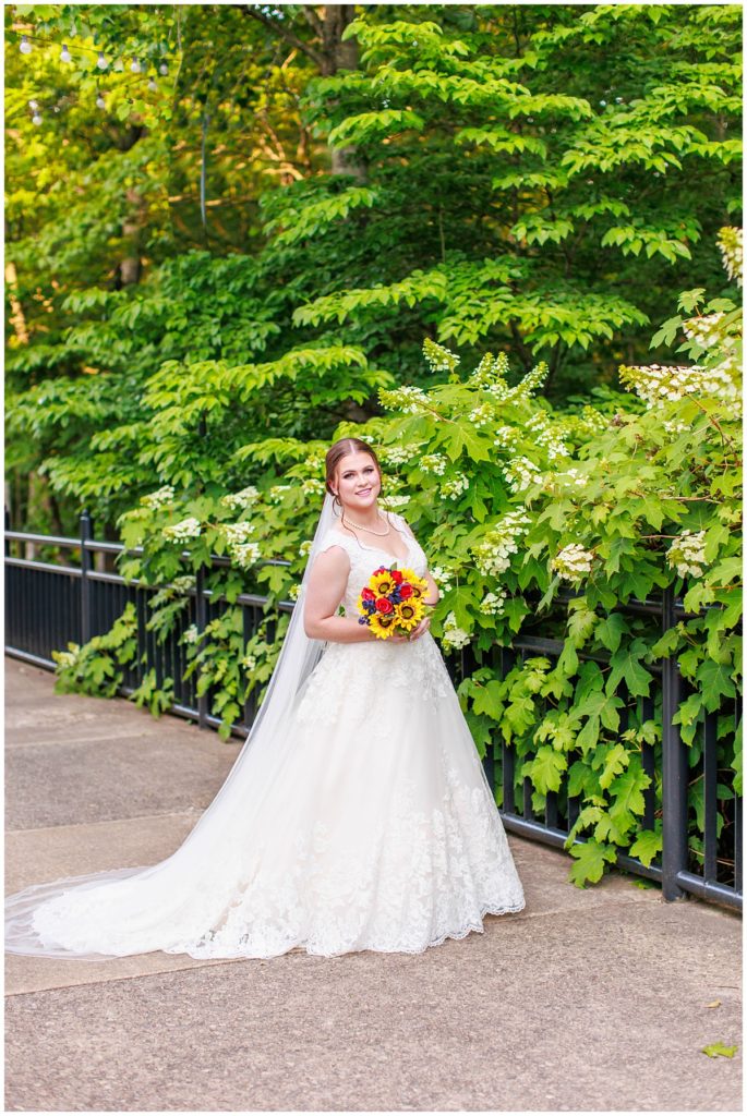 bride holds bouquet at the NC Arboretum