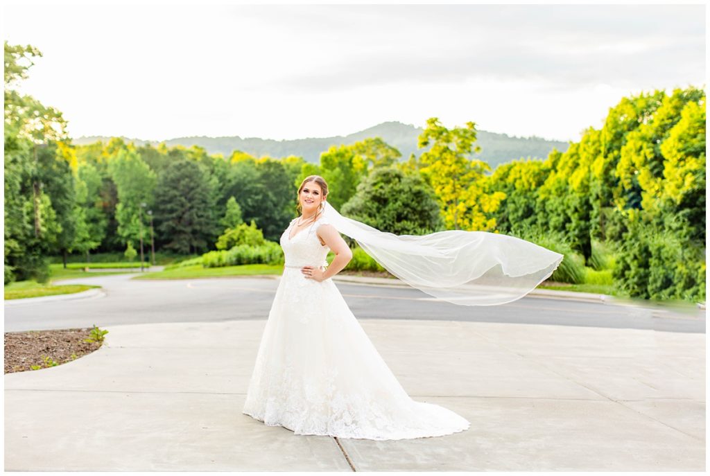 bride poses with mountains behind her