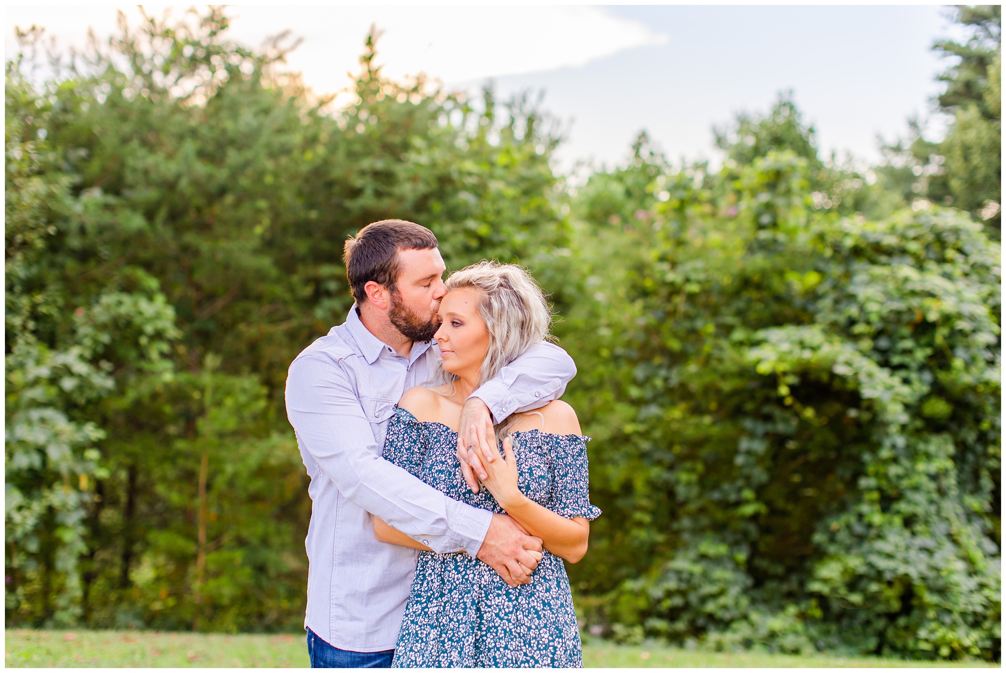 couple poses outdoors at a park for their anniversary session