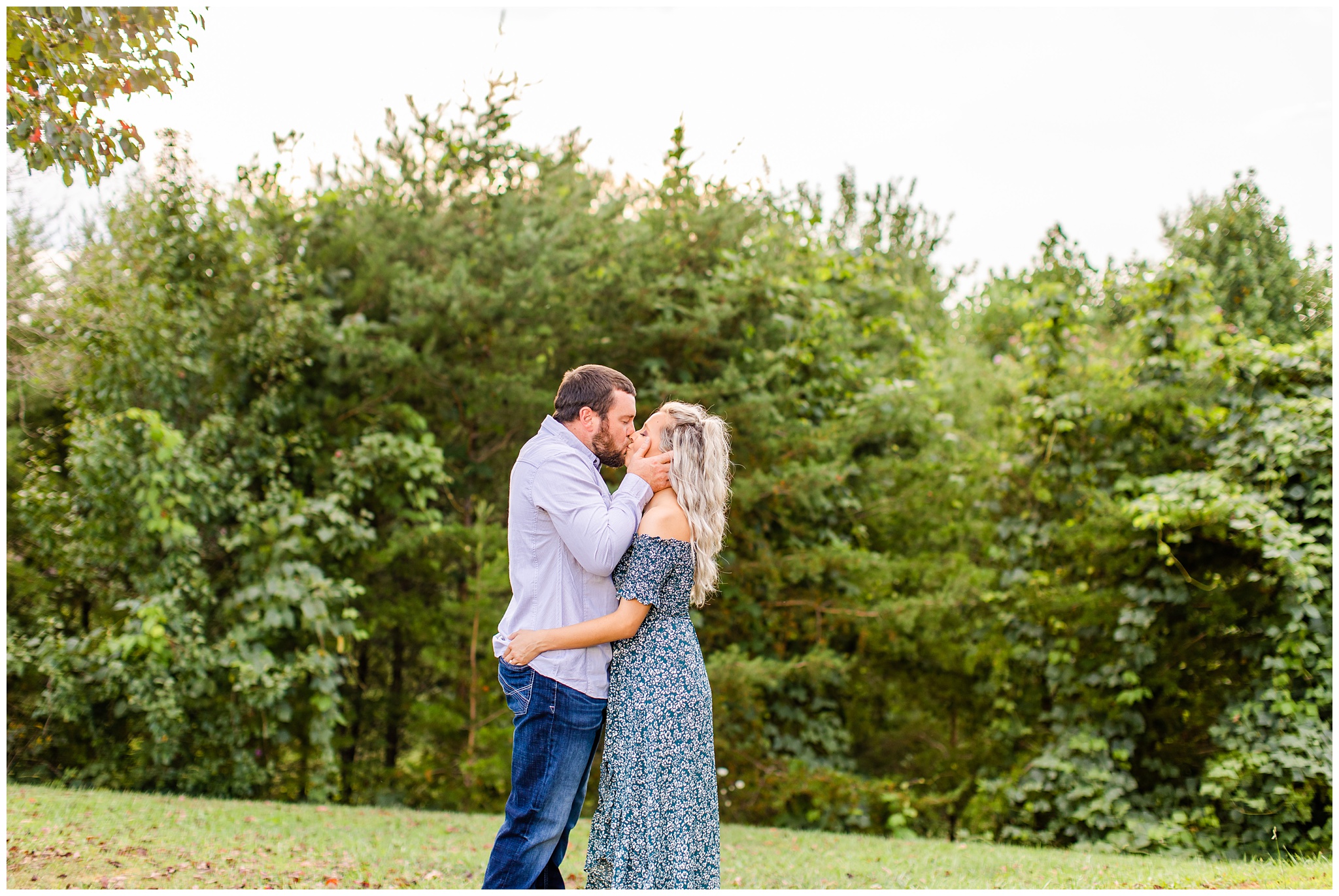 couple shares a kiss for an outdoor photo shoot