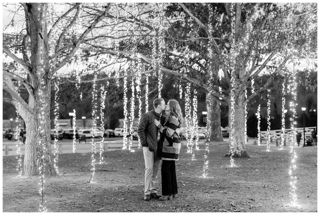 black and white photo of couple in hanging twinkle lights
