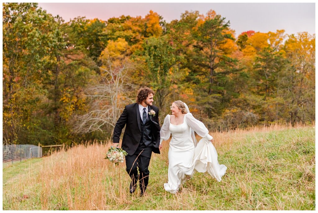 bride and groom running through field at chestnut ridge