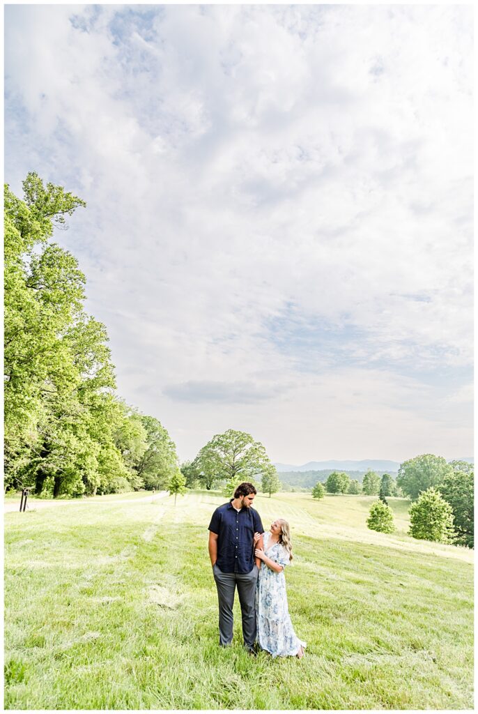 couple standing in field at biltmore estate