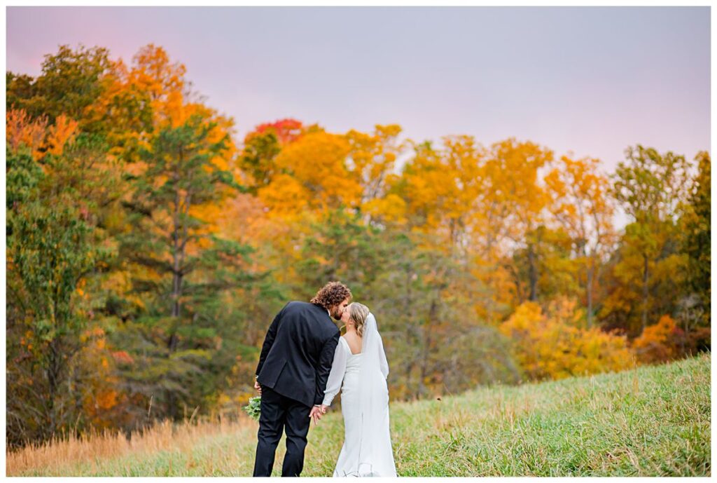 fall colors with bride and groom kissing